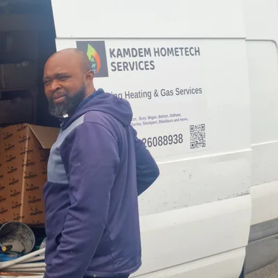 Appolin Kamdem loading tools from his Kamdem HomeTech van before a heating job in Greater Manchester