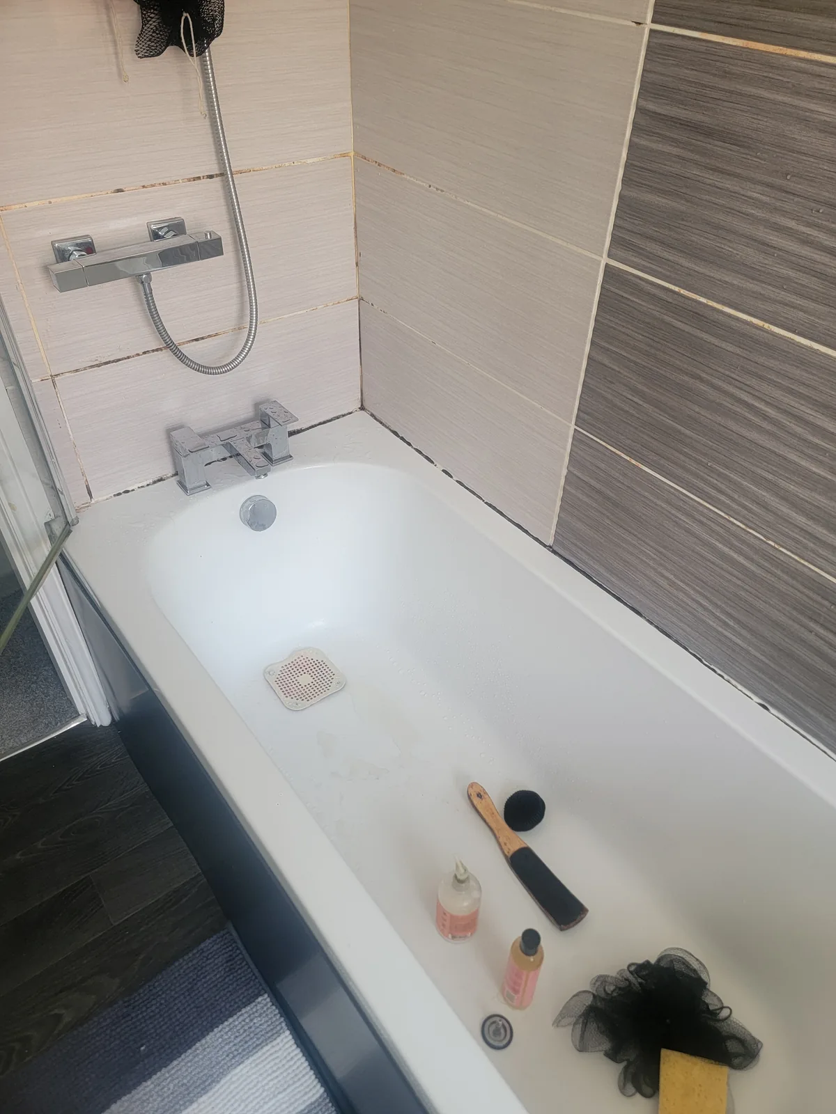 Bath silicone sealant with black mould and failed joints in Oldham — before renewal by Kamdem HomeTech, Gas Safe 559988